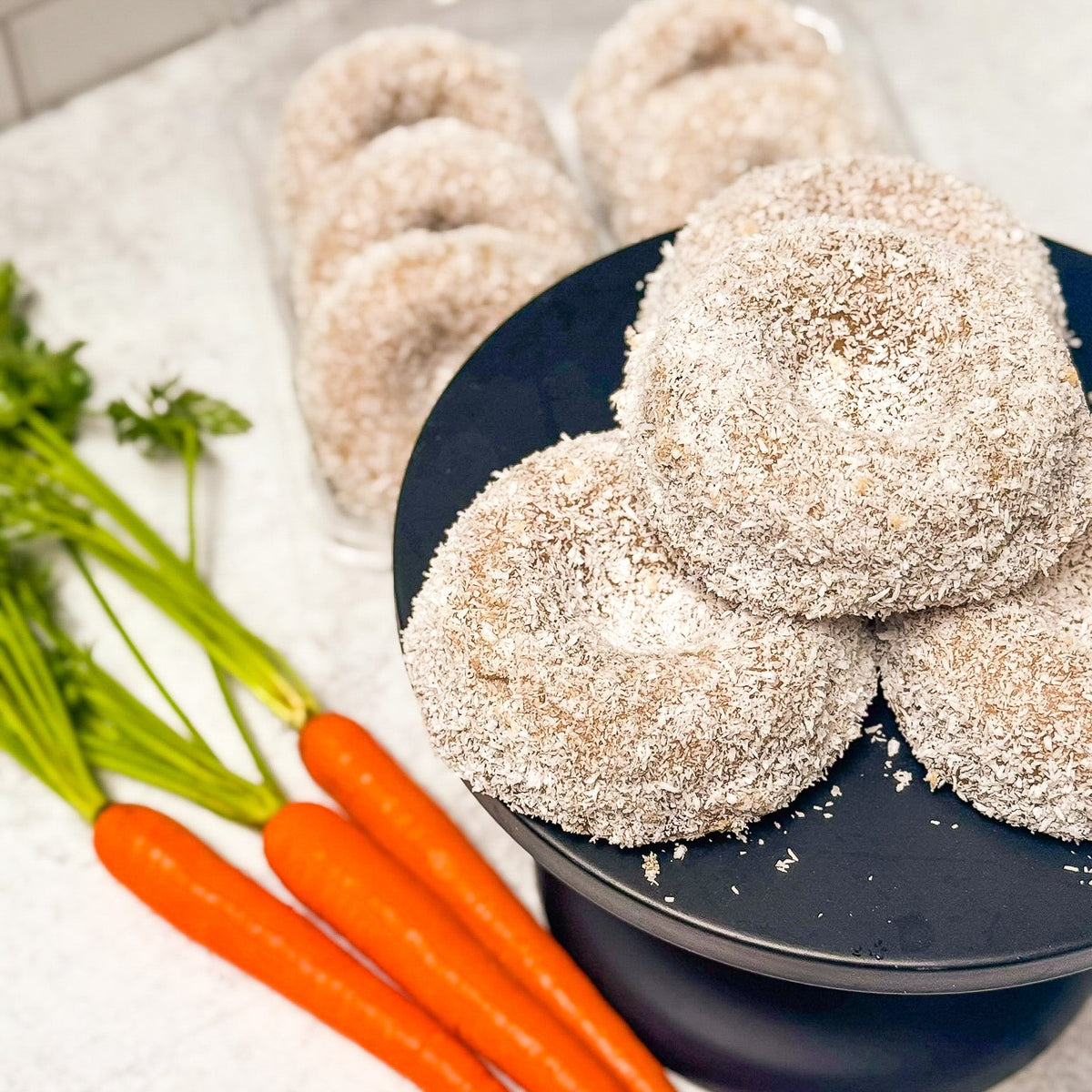 Gluten Free Carrot Maple Donuts on a cake stand for Easter