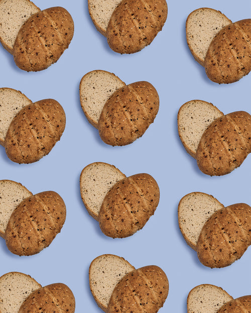 Gluten Free Everything Bread Loaves cut open through the middle and halves shifted to look like a heart