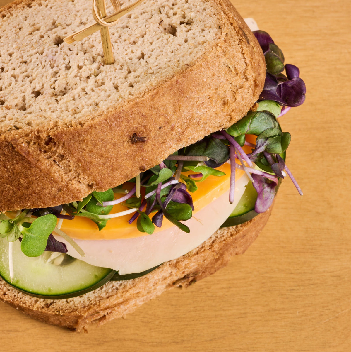 Sandwich with greens turkey and cheese made with gluten free garlic bread