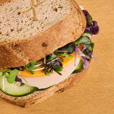 Sandwich with greens turkey and cheese made with gluten free garlic bread