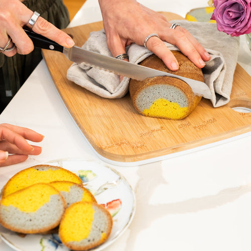 Slicing beautiful Gluten Free bread colored with Turmeric and Butterfly Pea Flower Powder