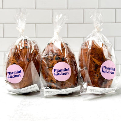 Chocolate cinnamon bread on a wooden board with a heart-shaped card on a red patterned background