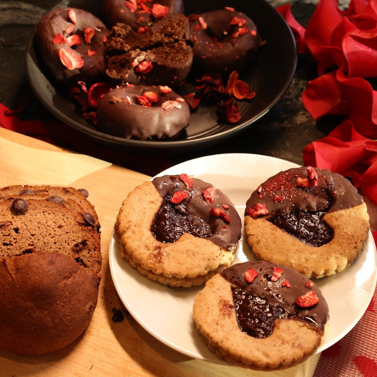 Assorted cookies on a plate with a wooden board and red fabric background